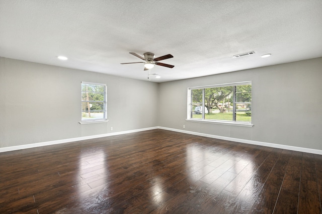 spare room featuring ceiling fan, dark hardwood / wood-style floors, and a textured ceiling