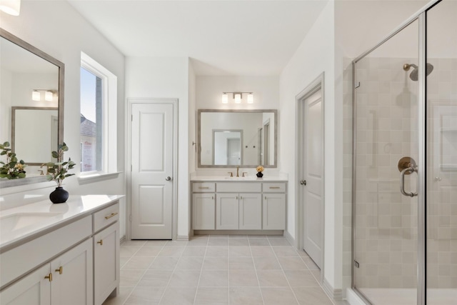 full bath featuring two vanities, a sink, and a shower stall