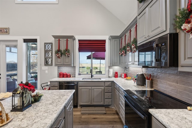 kitchen featuring gray cabinets, decorative backsplash, plenty of natural light, and appliances with stainless steel finishes