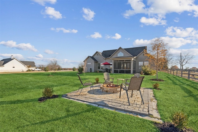 view of yard featuring an outdoor fire pit, a patio area, and a sunroom