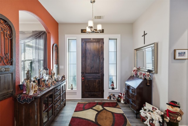 foyer featuring dark hardwood / wood-style flooring and a notable chandelier