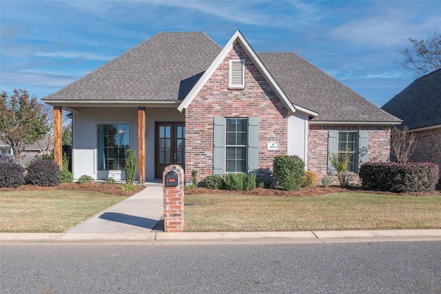 view of front of property featuring french doors and a front yard