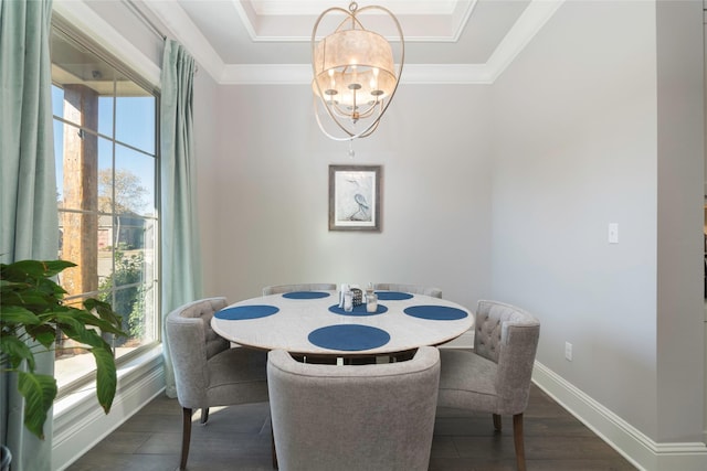 dining room featuring dark hardwood / wood-style flooring, ornamental molding, a wealth of natural light, and an inviting chandelier