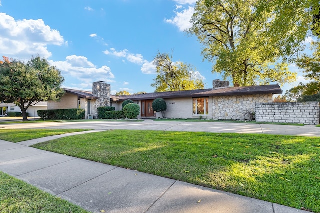 ranch-style house with a front lawn