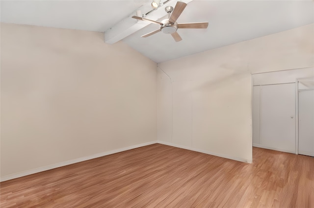 spare room featuring light hardwood / wood-style flooring, lofted ceiling with beams, and ceiling fan