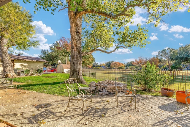 view of patio featuring a rural view and a storage unit