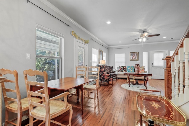 dining area featuring ceiling fan, ornamental molding, and hardwood / wood-style flooring