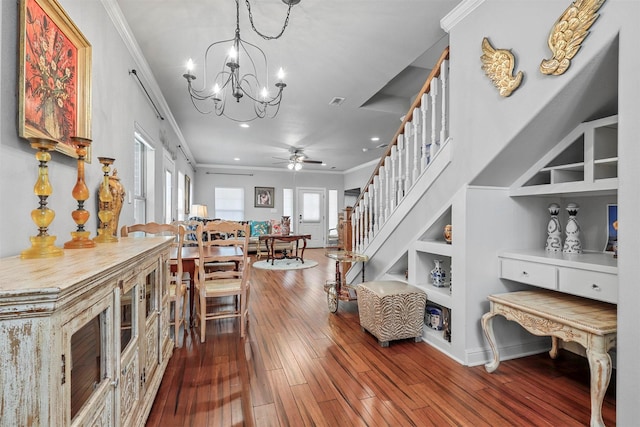 living room featuring ornamental molding, stairway, wood finished floors, and built in features