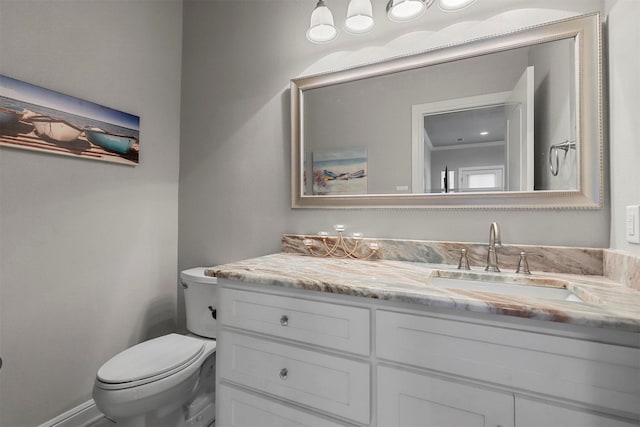 bathroom featuring toilet and vanity