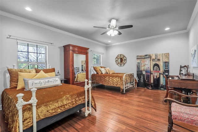 bedroom featuring multiple windows, crown molding, and wood finished floors