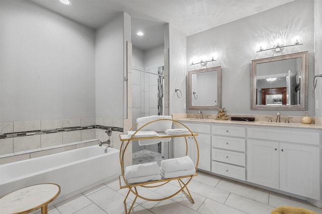 bathroom featuring tile patterned flooring, a garden tub, a sink, and a shower stall