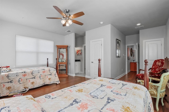 bedroom featuring ceiling fan, ensuite bathroom, and dark wood-type flooring