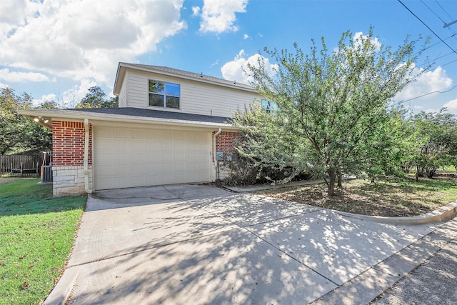 traditional-style home with an attached garage, concrete driveway, and brick siding