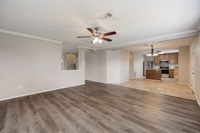 unfurnished living room featuring ornamental molding, ceiling fan with notable chandelier, a textured ceiling, and light wood-type flooring