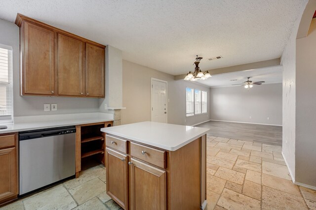 kitchen with pendant lighting, dishwasher, a center island, a textured ceiling, and ceiling fan with notable chandelier