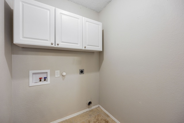 washroom with hookup for a washing machine, cabinets, a textured ceiling, hookup for a gas dryer, and hookup for an electric dryer