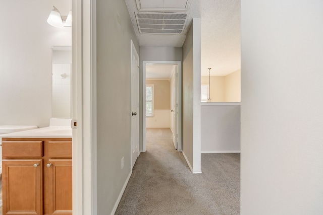 corridor featuring light colored carpet