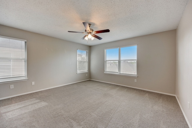 unfurnished room with a textured ceiling, light colored carpet, and ceiling fan