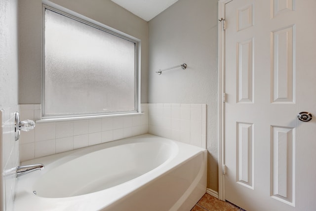 bathroom featuring tile patterned flooring and a bathtub