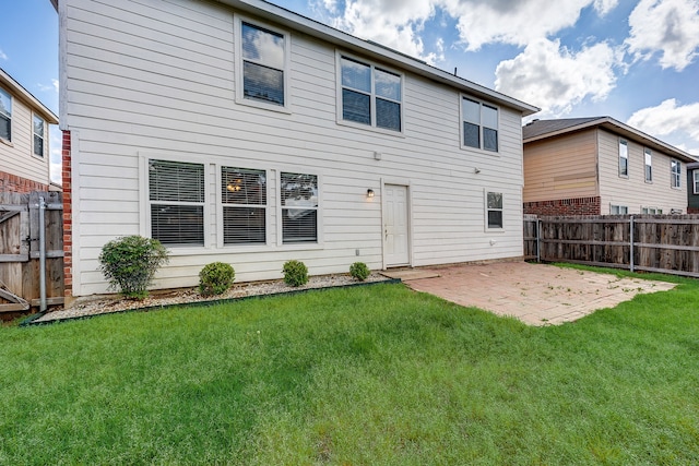 back of property featuring a patio and a yard