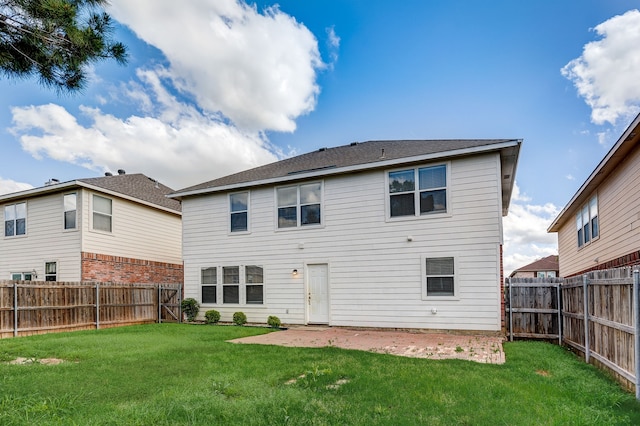 back of house featuring a patio area and a lawn