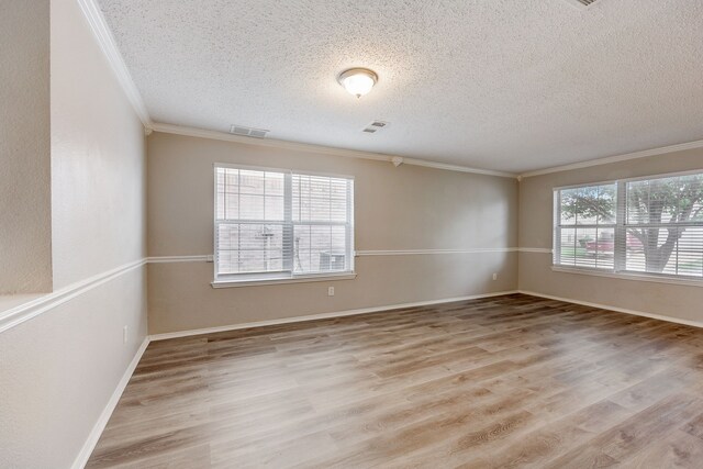 unfurnished room featuring ornamental molding, light hardwood / wood-style floors, and a textured ceiling