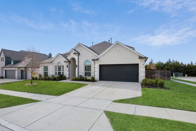 ranch-style house featuring a yard and a garage