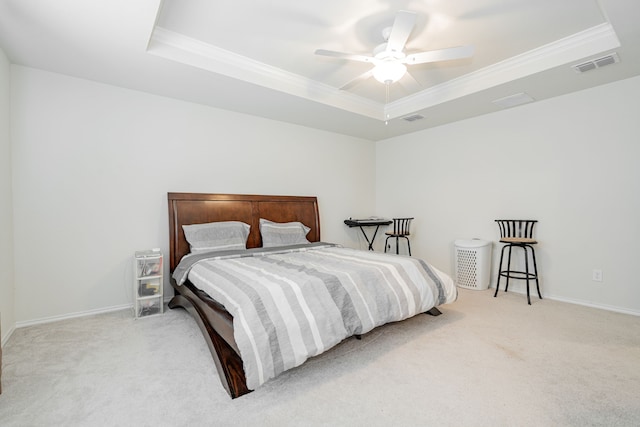 bedroom with a raised ceiling, ceiling fan, crown molding, and light colored carpet