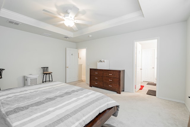 carpeted bedroom with a raised ceiling, ceiling fan, and ornamental molding