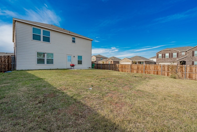 back of house with a yard