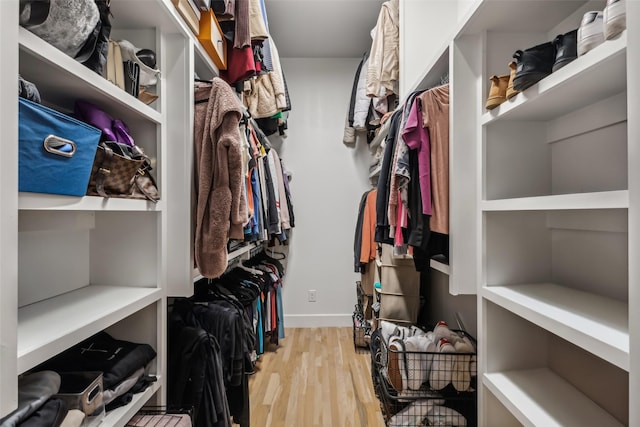 walk in closet featuring light hardwood / wood-style flooring