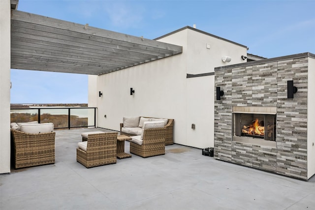 view of patio featuring a pergola and exterior fireplace