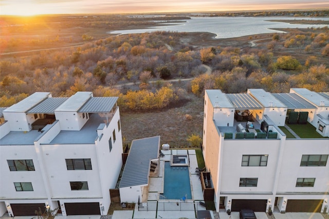 aerial view at dusk with a water view