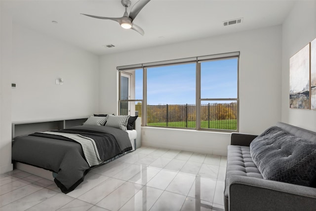 bedroom featuring light tile patterned floors, multiple windows, and ceiling fan