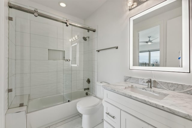 full bathroom featuring ceiling fan, toilet, vanity, and combined bath / shower with glass door