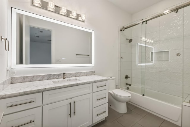 full bathroom with tile patterned floors, vanity, toilet, and combined bath / shower with glass door