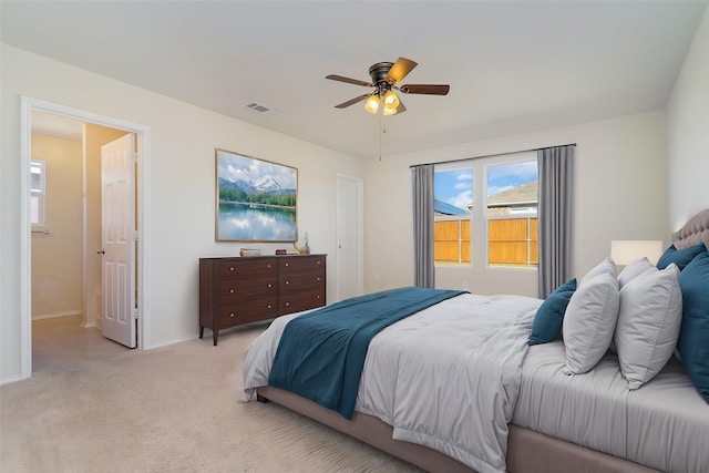 bedroom featuring light colored carpet and ceiling fan