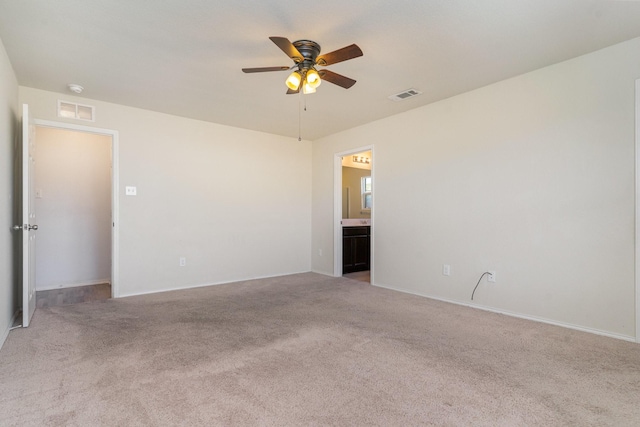 empty room with light colored carpet and ceiling fan