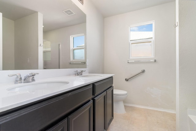 bathroom with a shower, vanity, and toilet