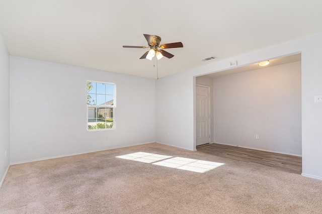 unfurnished room with light carpet and ceiling fan