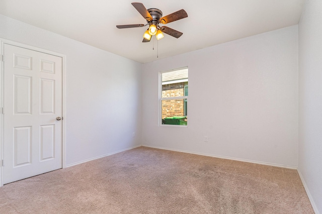 unfurnished room with ceiling fan and light colored carpet