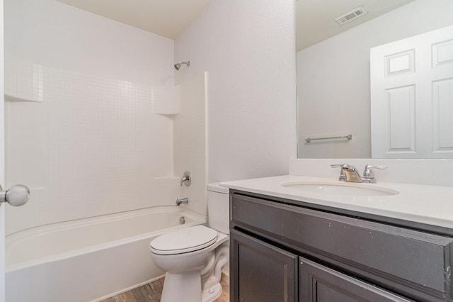 full bathroom featuring vanity, hardwood / wood-style flooring, toilet, and shower / washtub combination