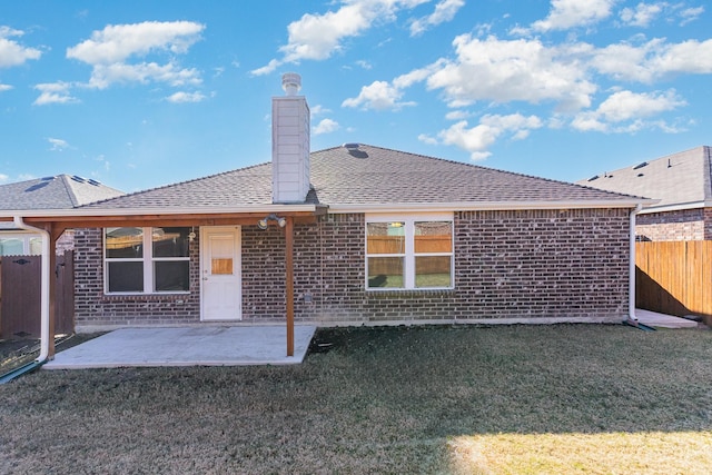 back of house with a lawn and a patio