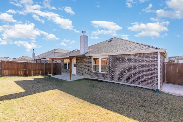 rear view of property with a patio area and a lawn