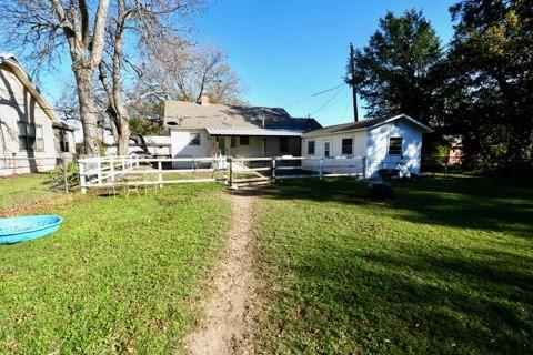 back of property featuring a yard