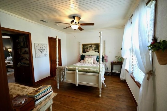 bedroom featuring ceiling fan, wooden ceiling, dark wood-type flooring, and ornamental molding