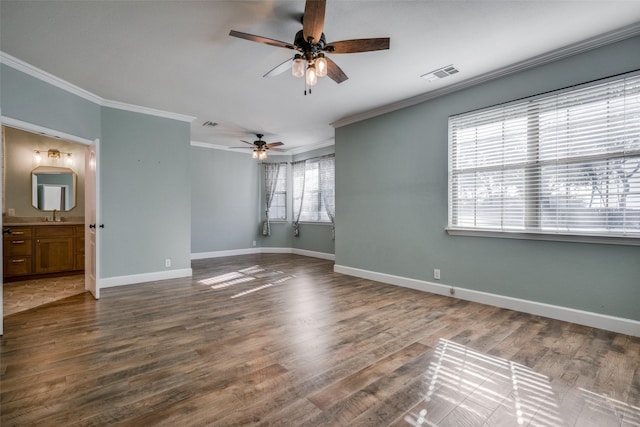 unfurnished room featuring hardwood / wood-style flooring, ceiling fan, ornamental molding, and sink