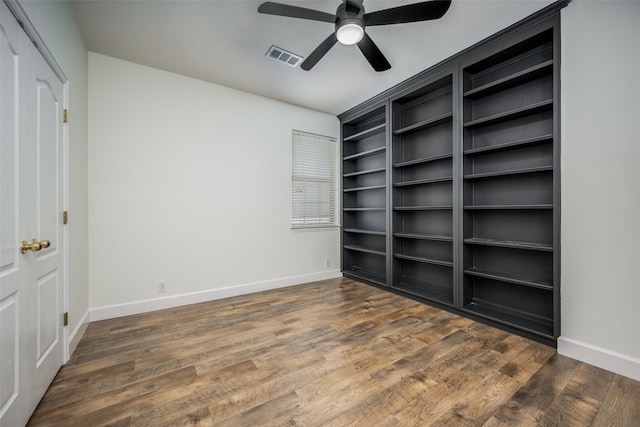 unfurnished bedroom featuring ceiling fan and dark hardwood / wood-style flooring