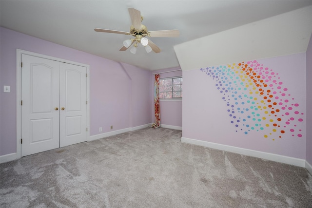 additional living space featuring light carpet and ceiling fan