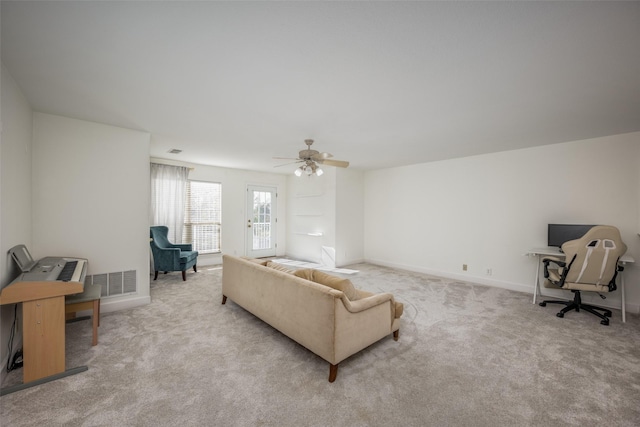 living room with ceiling fan and light carpet